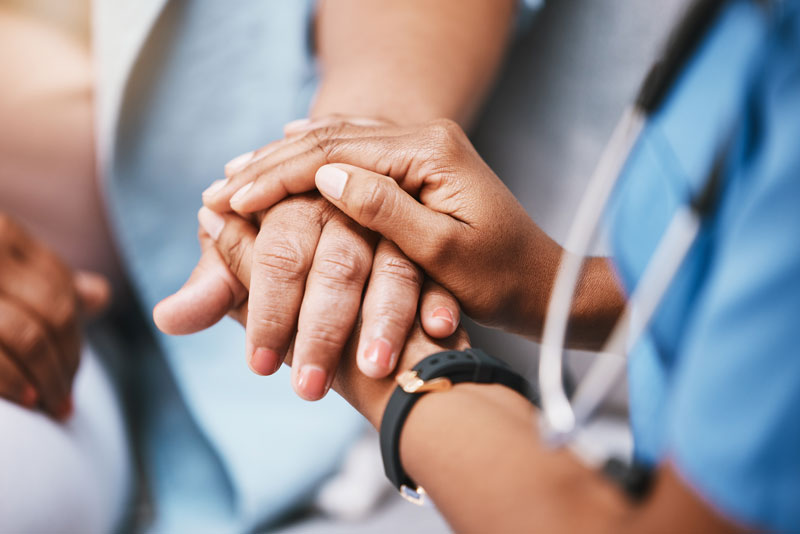 Image of hands holding caring for patient